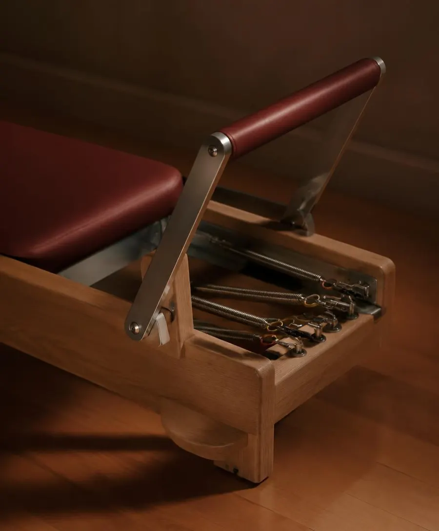 Reformer foot bar and springs with wine leather upholstery